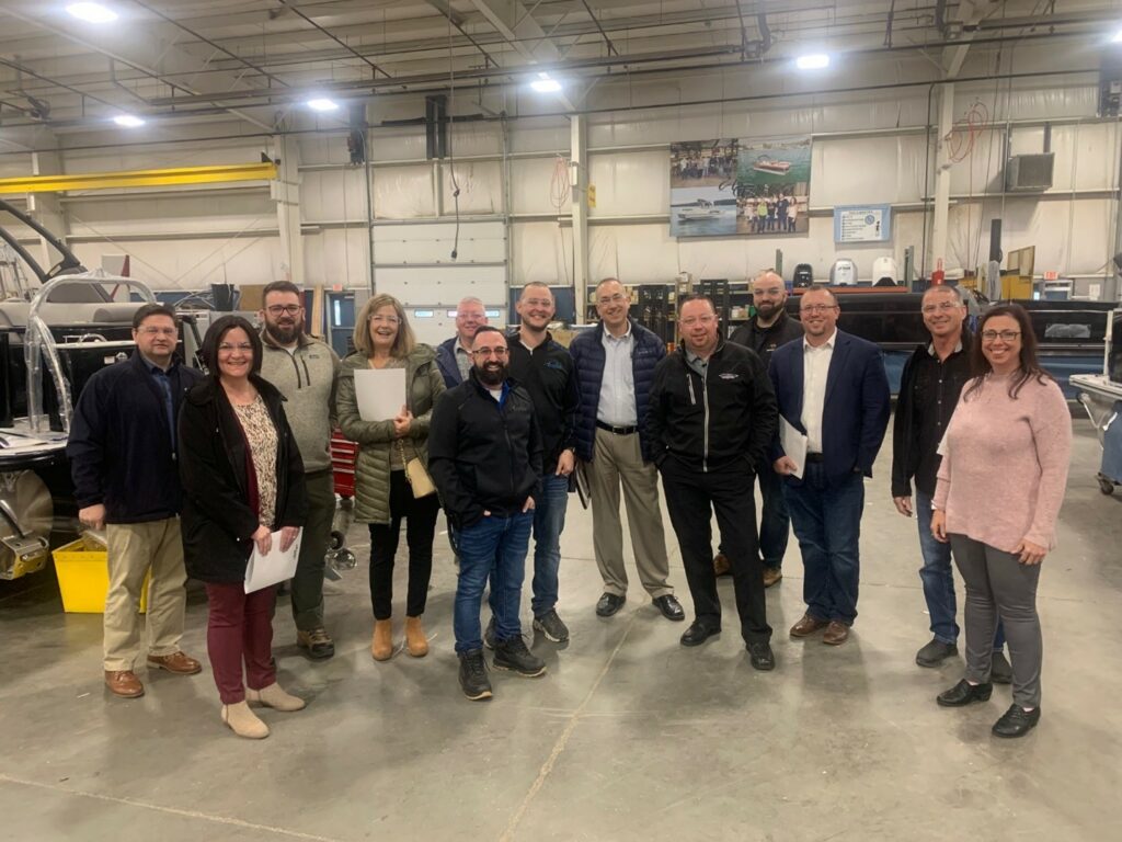 Group of people touring a manufacturing facility.