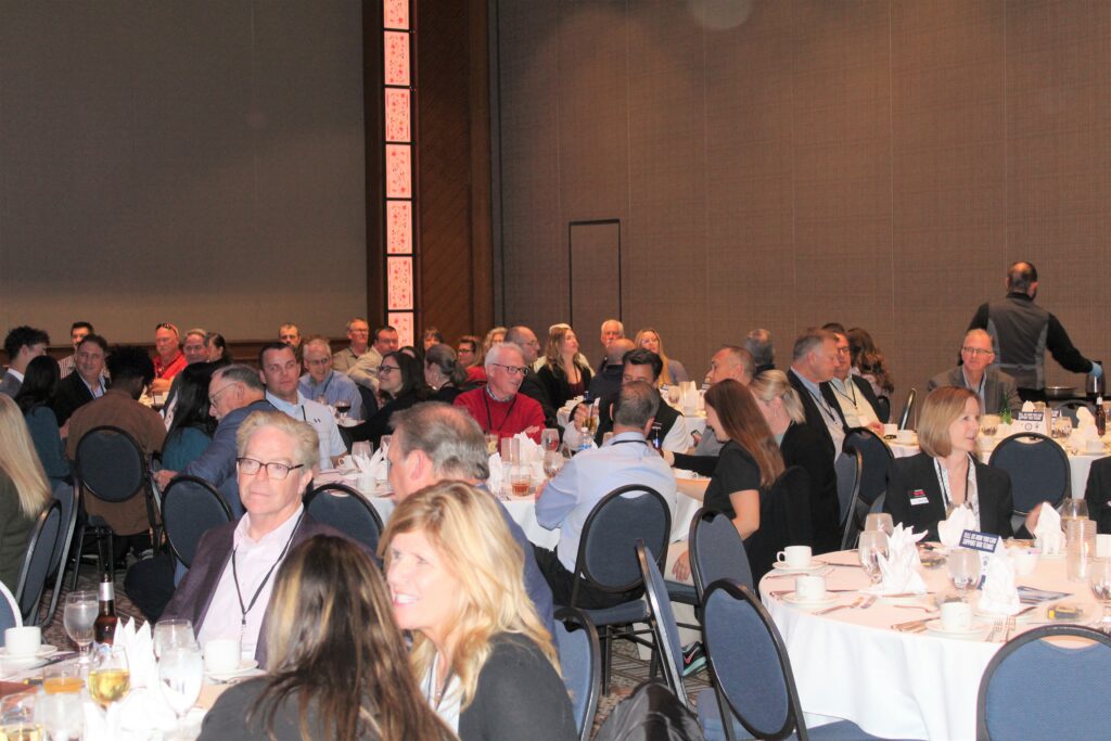 People attending a large conference banquet.