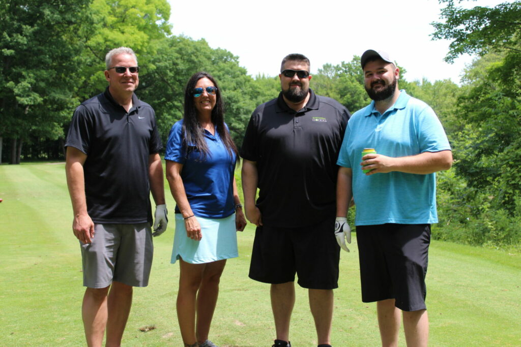 Group enjoying a sunny day on the golf course.