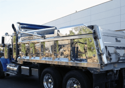 Shiny chrome dump truck parked outdoors