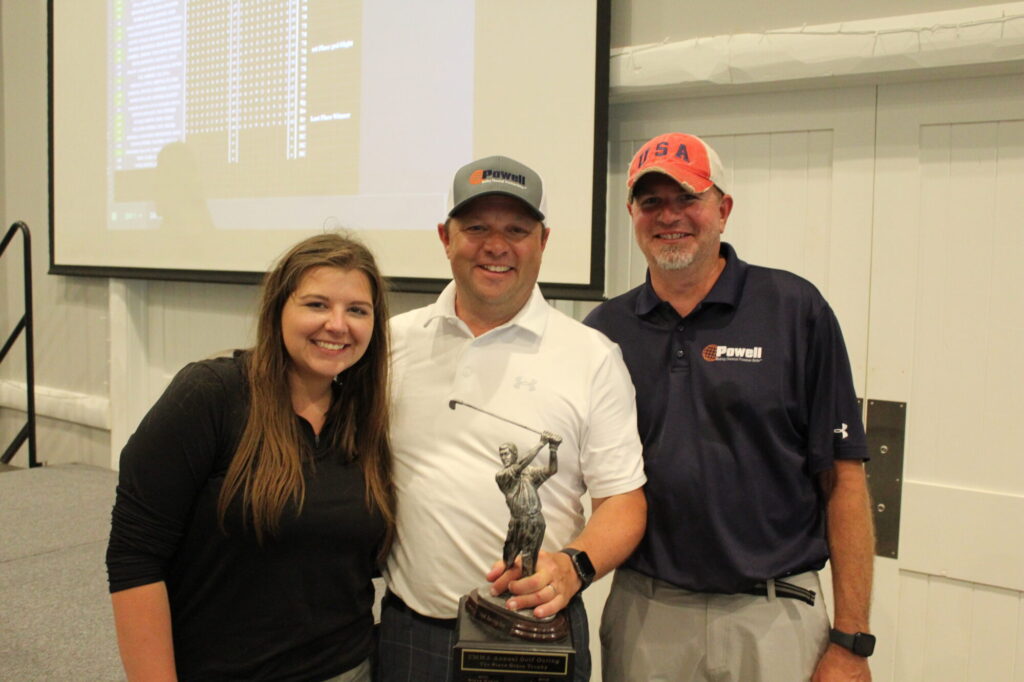 Group photo with golf trophy.