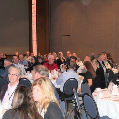 People attending a large conference banquet.