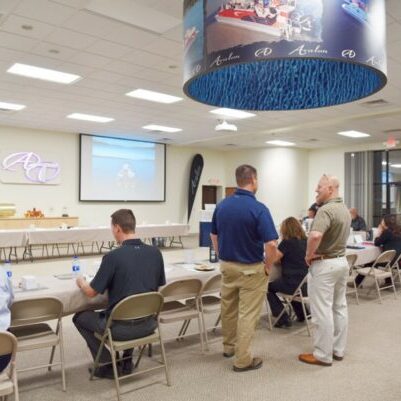 Business meeting in conference room with presentation.