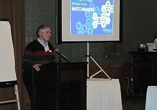 Speaker presenting at a conference.