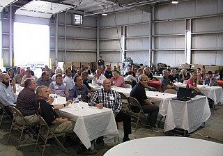 Group attending a seminar in an industrial space.