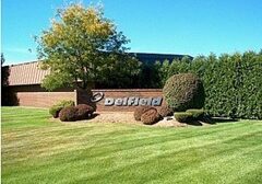 Deifield building sign with landscaped greenery