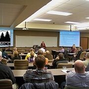 Meeting at community college with presentation screen.