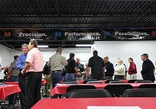 People networking at an industrial event with banners